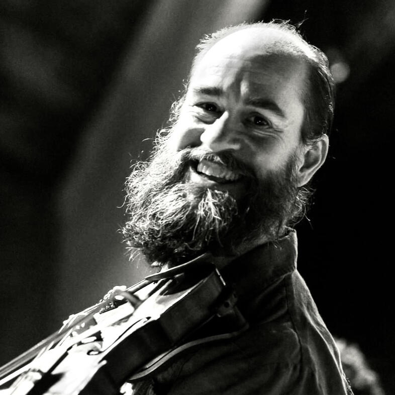 Rex McGee plays fiddle on stage